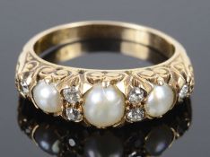 An attractive Victorian style pearl and diamond set scroll mounted ring