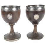 A pair of George III silver-mounted coconut goblets