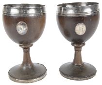 A pair of George III silver-mounted coconut goblets