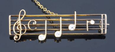 An amusing early twentieth century diamond set musical score brooch