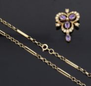 An attractive Edwardian style amethyst and seed pearl pendant brooch on fancy chain