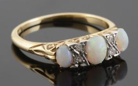 An Edwardian three stone opal set ring