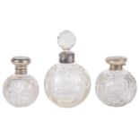 Three early 20th century dressing table glass and silver scent bottles