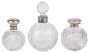 Three early 20th century dressing table glass and silver scent bottles