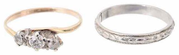 A three stone diamond set twist ring and a platinum band