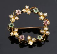 A delicate Edwardian pink and green gem and seed pearl set brooch