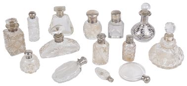 A collection of early 20th century miniature silver and glass scent bottles