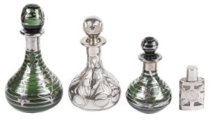 Two early 20th century green glass and white metal overlay perfume bottles and two others