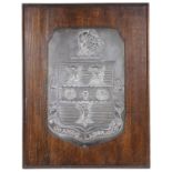 A wooden mounted shield plaque bearing coat of arms for Rugby School by Fisher and Ludlow