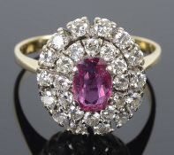 A Continental ruby and diamond oval cluster ring