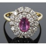 A Continental ruby and diamond oval cluster ring