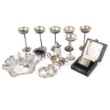 A collection of assorted silver, napkin rings, bon bon dish, cruets, silver cups