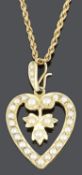 A charming late Victorian 15ct gold and seed pearl heart shaped pendant