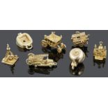 A charming contemporary collection of seven 9ct mostly articulated charms
