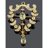 An Art Nouveau peridot and seed pearl pendant brooch