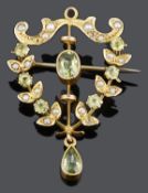 An Art Nouveau peridot and seed pearl pendant brooch