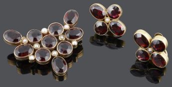 A large Victorian garnet set brooch and matching earrings