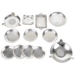 A collection of silver ashtrays