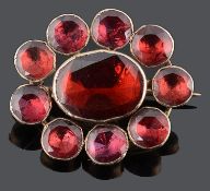 A small attractive Georgian foil backed flat cut garnet set brooch