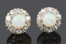 A pair of attractive opal and old cut diamond set earrings