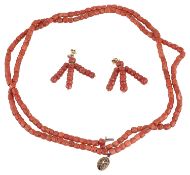 A deep red coral bead two row necklace and drop earrings