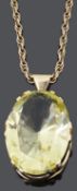 An impressive large gold mounted yellow gem set pendant, c1970