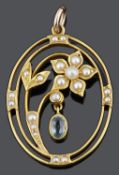 An Attractive Edwardian aquamarine and seed pearl floral pendant