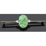 An Art Deco carved green jade and diamond set bar brooch