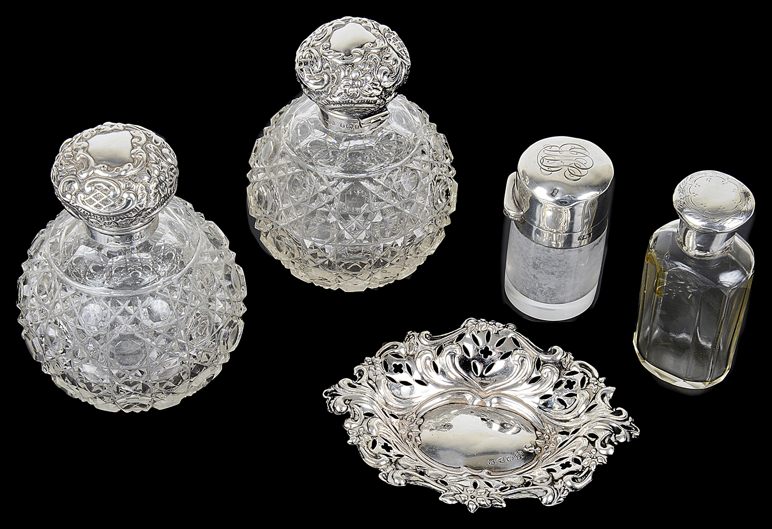 A selection of Victorian silver capped glass scent bottle and a silver trinket tray