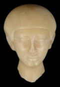 An Egyptian alabaster sculpture fragment of a head.