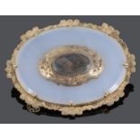 An early Victorian gold mounted chalcedony mourning brooch