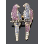 An amusing Victorian style diamond and gem pave set twin parrot brooch