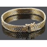 A contemporary 9ct gold brick link woven bracelet