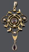 A delicate Edwardian garnet set foliate pendant