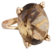 A large oval smoky quartz set dress ring