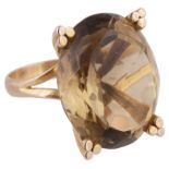 A large oval smoky quartz set dress ring