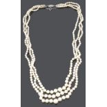 An attractive long three row cultured pearl necklace