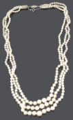 An attractive long three row cultured pearl necklace