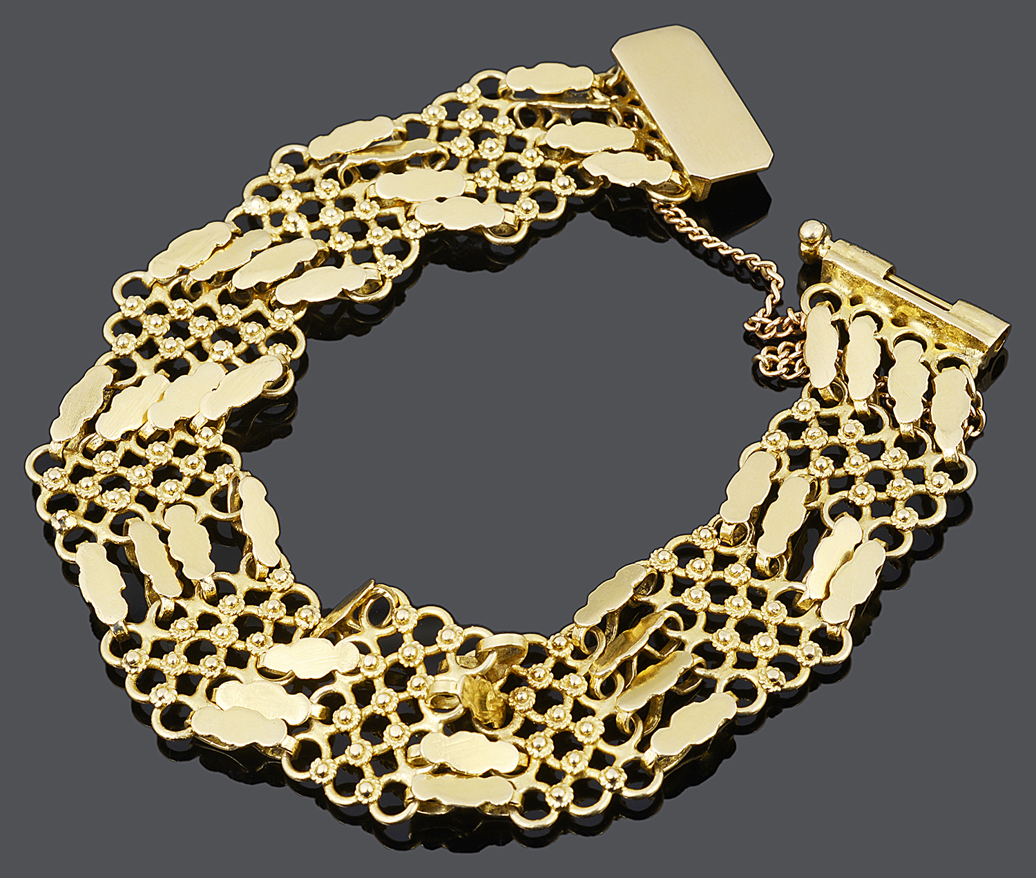 An eastern 18ct gold honeycomb panel bracelet