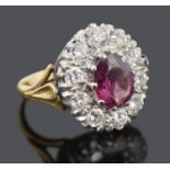 A large pink gem and diamond set oval cluster ring