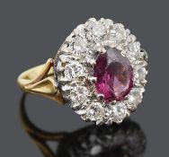 A large pink gem and diamond set oval cluster ring