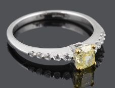 A delicate natural fancy intense yellow diamond set ring