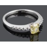 A delicate natural fancy intense yellow diamond set ring