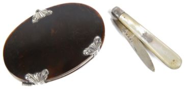 An oval silver mounted tortoiseshell magnifier