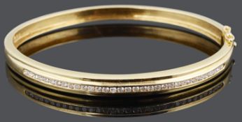A Continental gold and diamond set hinged bangle