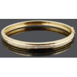 A Continental gold and diamond set hinged bangle