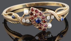 A Victorian style diamond and gem set hinged bangle