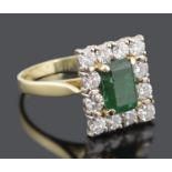 A large Continental rectangular emerald and diamond set cluster ring