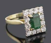 A large Continental rectangular emerald and diamond set cluster ring