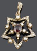 A delicate garnet and seed pearl star shaped pendant